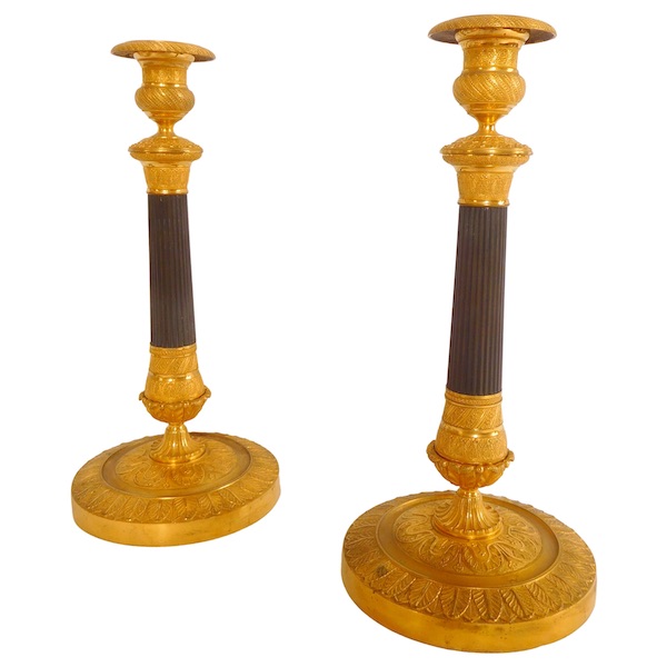 Pair of patinated bronze and ormolu candlesticks, early 19th century