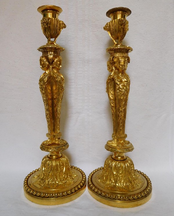 Pair of ormolu Louis XVI style candlesticks, after Jean Demosthenes Dugourc