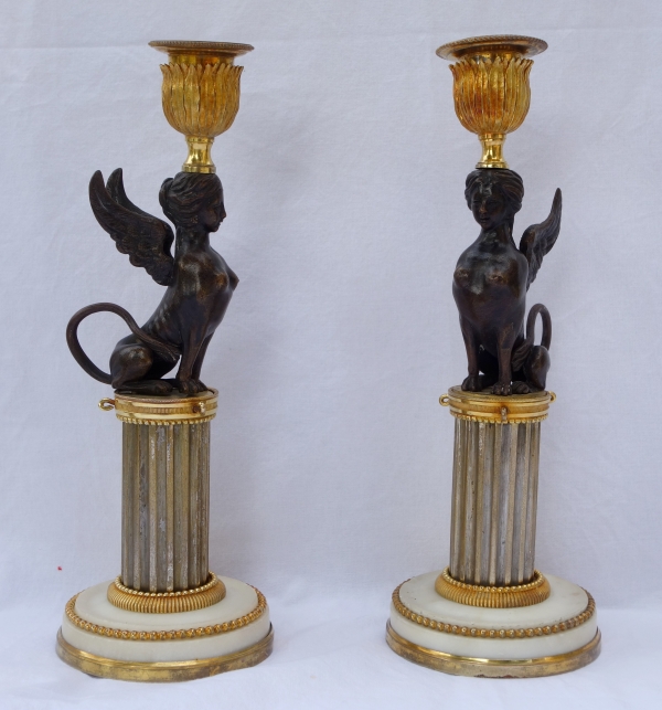 Pair of Directoire ormolu and bronze candlesticks, late 18th century