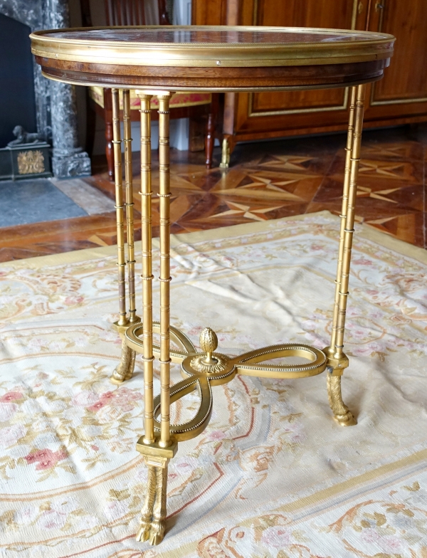 Pair of bronze, marble and mahogany pedestal tables after Weisweiler, Louis XVI style