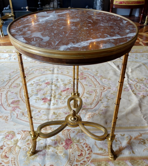 Pair of bronze, marble and mahogany pedestal tables after Weisweiler, Louis XVI style