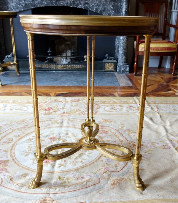 Pair of bronze, marble and mahogany pedestal tables after Weisweiler, Louis XVI style