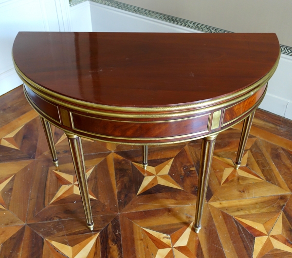 Mahogany half moon shaped game table, Louis XVI period, late 18th century