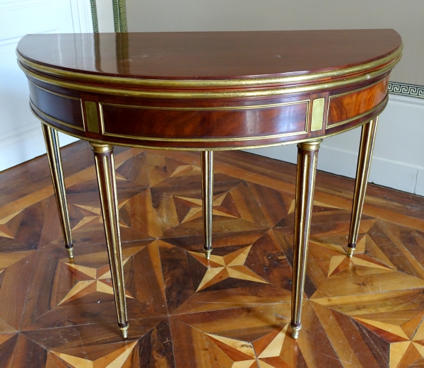 Mahogany half moon shaped game table, Louis XVI period, late 18th century
