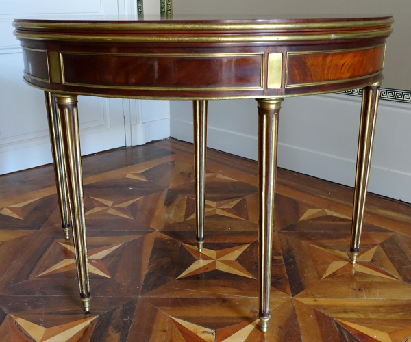 Mahogany half moon shaped game table, Louis XVI period, late 18th century