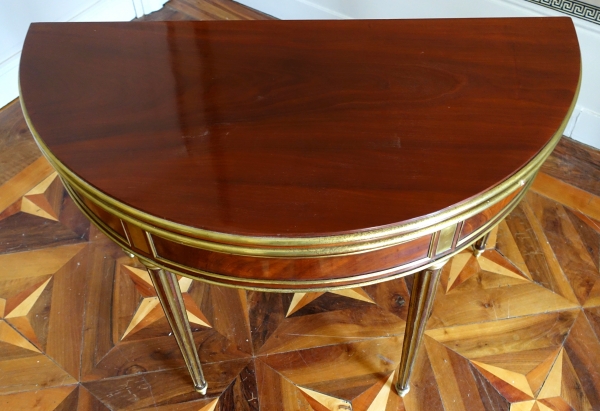 Mahogany half moon shaped game table, Louis XVI period, late 18th century