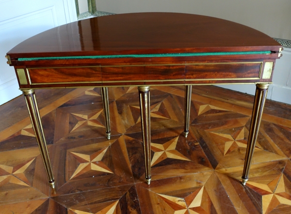 Mahogany half moon shaped game table, Louis XVI period, late 18th century