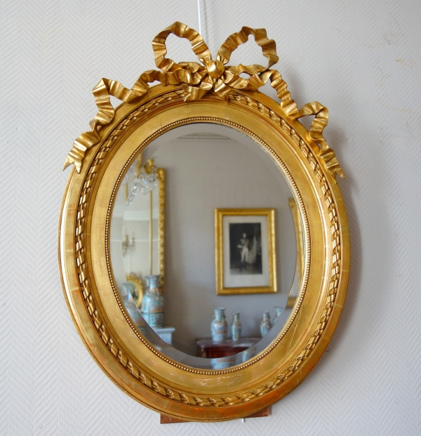Large oval Louis XVI style mirror, gold leaf gilt wood frame, Napoleon III period - 84cm x 63cm