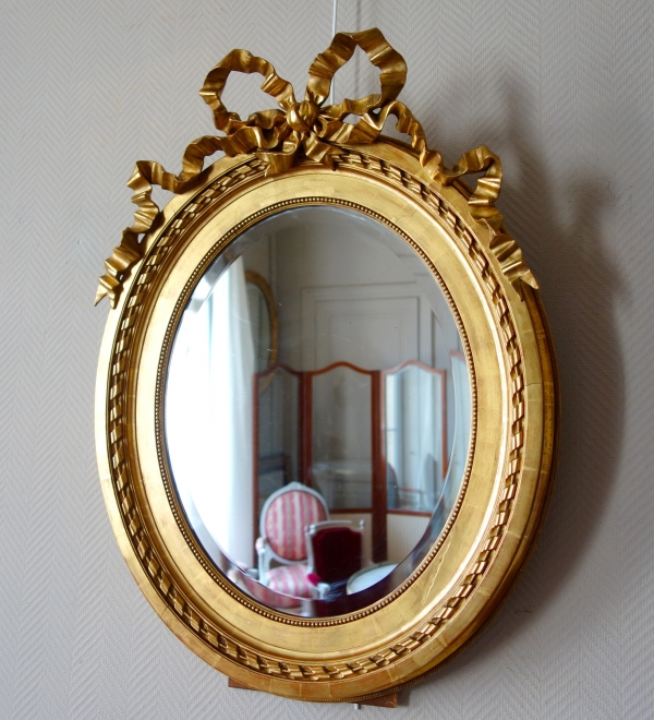 Large oval Louis XVI style mirror, gold leaf gilt wood frame, Napoleon III period - 84cm x 63cm