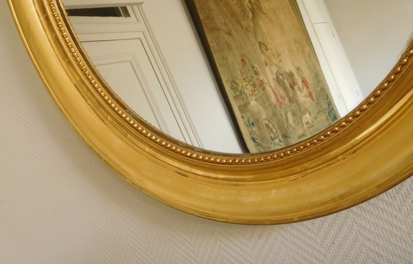 Miroir ovale XIXe en bois doré à la feuille d'or - glace au mercure - 76,5cm x 75cm