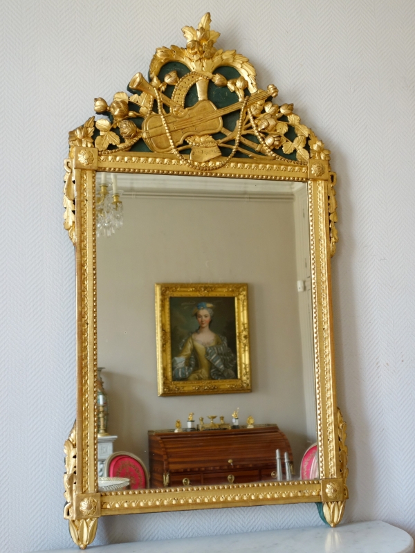 Tall Louis XVI mirror, music trophy patterned frame gilt with gold leaf - late 18th century