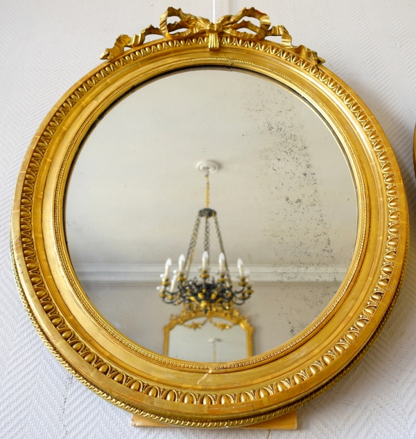Pair of Louis XVI style gold leaf gilt wood oval mirrors, 19th century