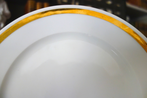 Set of 12 Paris porcelain dessert plates enhanced with fine gold, early 19th century