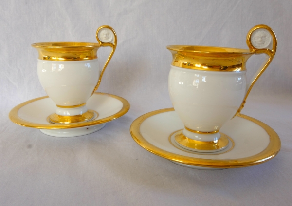 Pair of Empire Paris porcelain coffee cups enhanced with fine gold, early 19th century