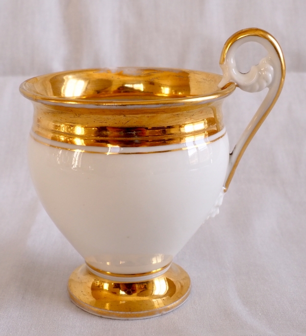 Pair of Empire Paris porcelain coffee cups enhanced with fine gold, early 19th century