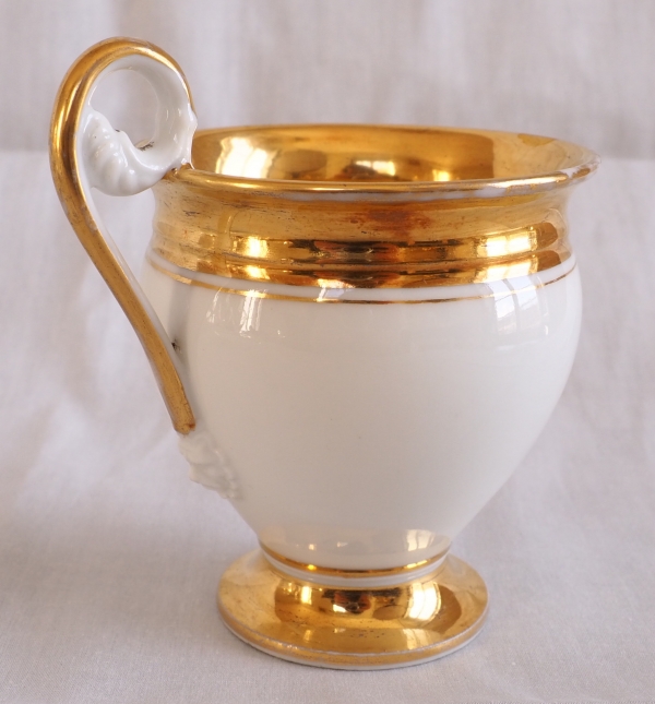 Pair of Empire Paris porcelain coffee cups enhanced with fine gold, early 19th century