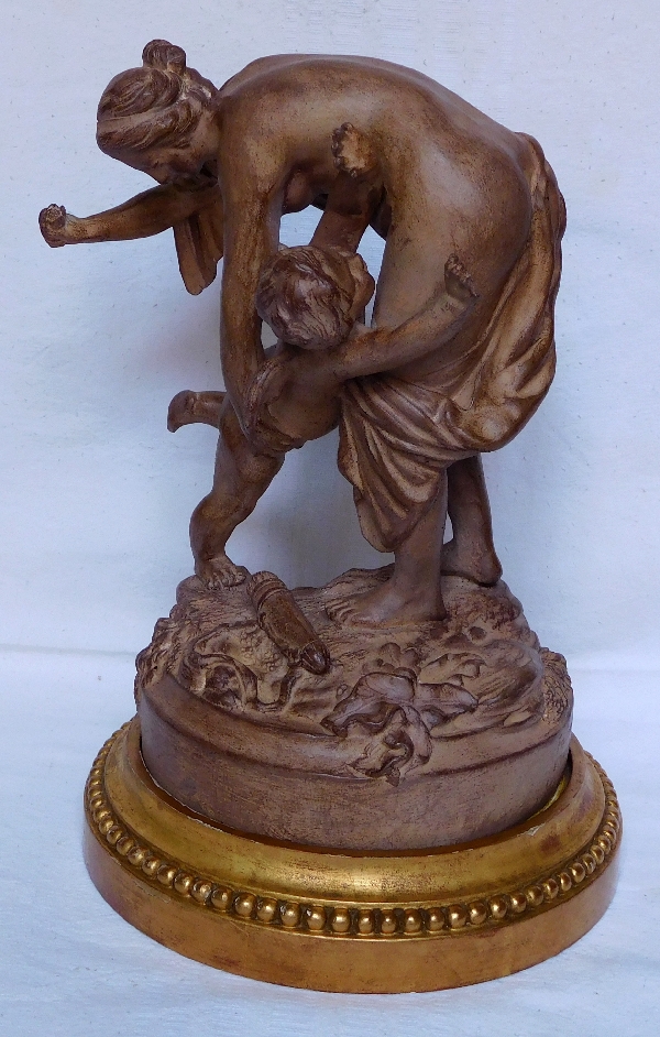 Venus gives Love a smack on the bottom, terra cotta, early 20th century