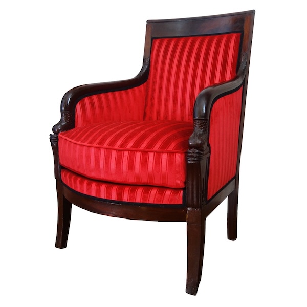 Empire mahogany bergere, dolphin-shaped armrests, early 19th century