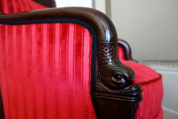 Empire mahogany bergere, dolphin-shaped armrests, early 19th century