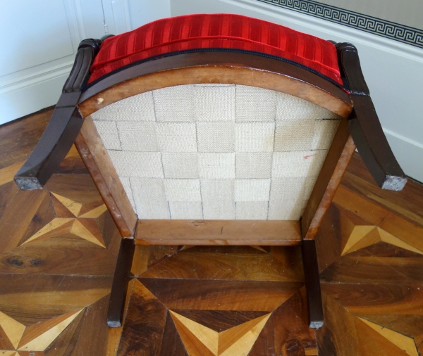 Empire mahogany bergere, dolphin-shaped armrests, early 19th century