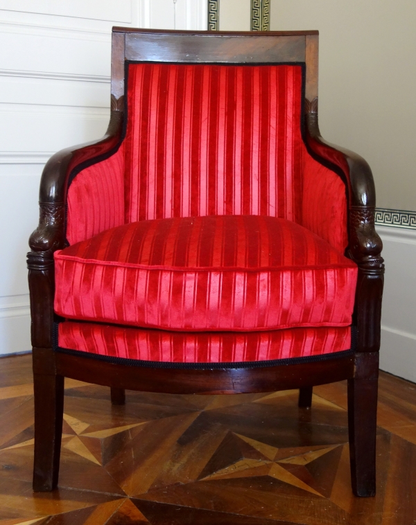 Empire mahogany bergere, dolphin-shaped armrests, early 19th century