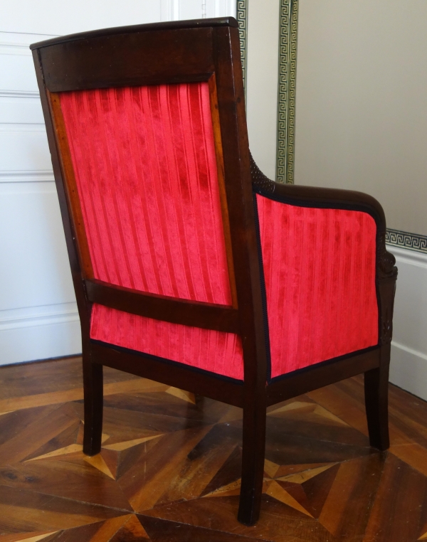 Empire mahogany bergere, dolphin-shaped armrests, early 19th century