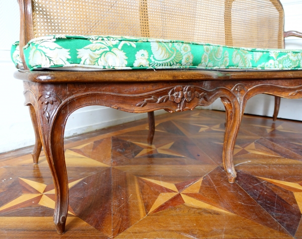 Louis XV walnut canned sofa, 18th century