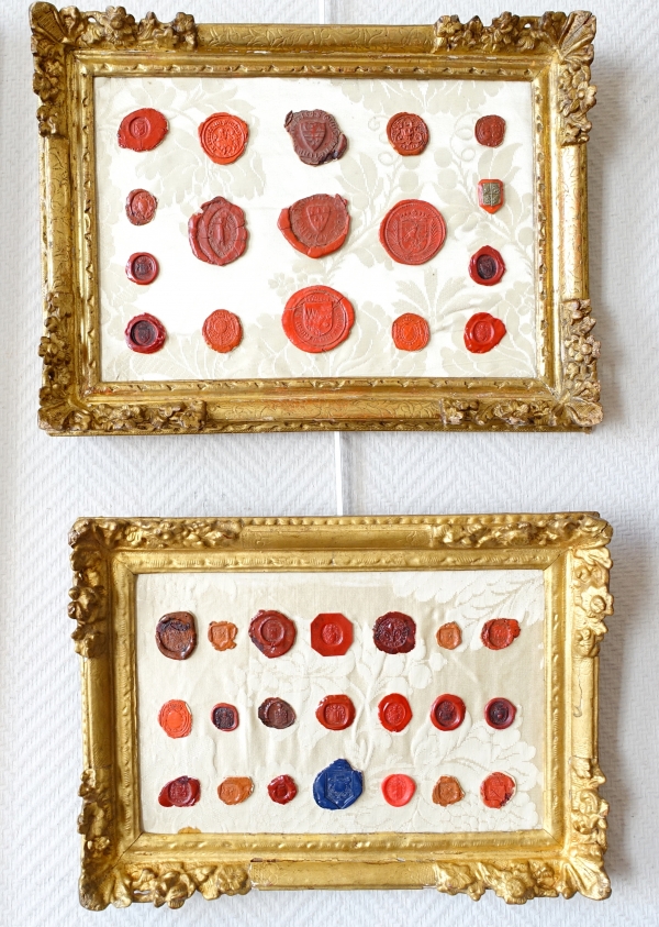 Detail — Heraldry : antique coat of arms stamps set into a Louis XIV gilt wood frame